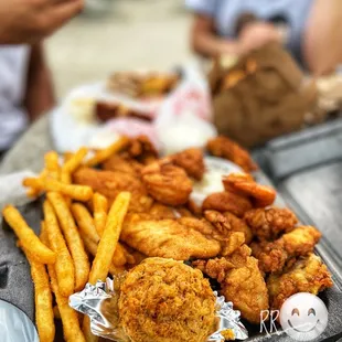 a tray of fried chicken and french fries