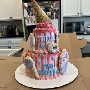 a birthday cake with ice cream and donuts