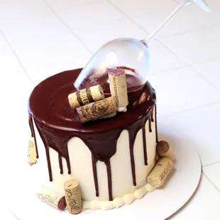 Funfetti cake with white butter and burgundy ganache drip.