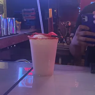 a person taking a picture of a drink