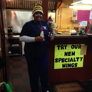 Suga with her cousin's famous wing sauces.