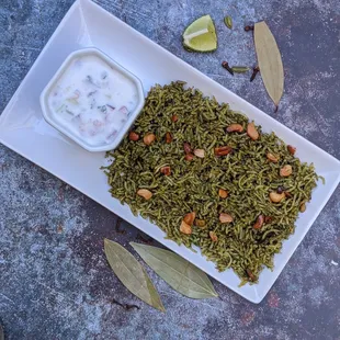 a plate of rice and a bowl of yogurt