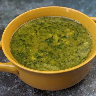 a yellow bowl of broccoli soup