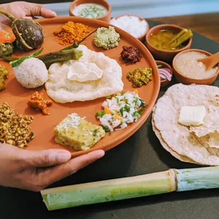a person holding a plate of food