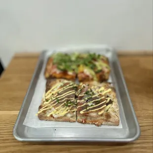 Japanese Slice: Sautéed mushrooms, mozzarella, bonito flakes, sliced porchetta, miso kewpie sauce and chopped chives | $8