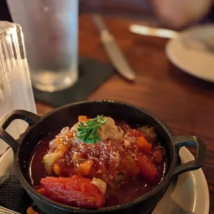 a bowl of stew on a plate