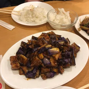 a plate of stir fried eggplant and rice