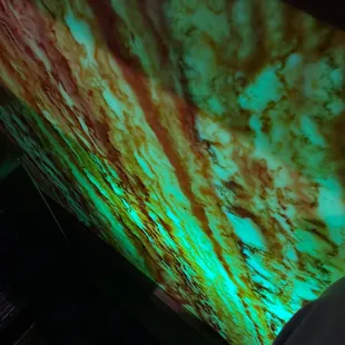 a person standing in front of a large screen