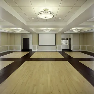 main room for rental featuring projector and digital sound system.