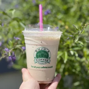 a hand holding a cup of coffee