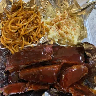 a tray of ribs, coleslaw, and french fries