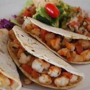 a plate of tacos and a salad