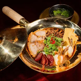 a bowl of food and a pot of soup