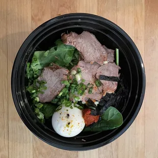 an overhead view of a bowl of food