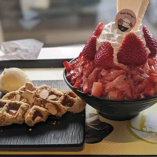 Injeolmi &amp; honey drizzled croffle with vanilla ice cream &amp; premium strawberry topped with a cheesecake.