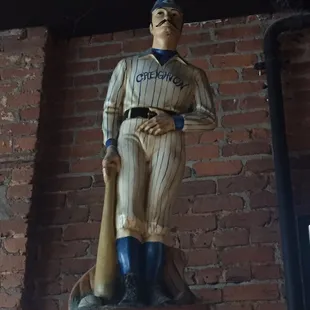 a statue of a baseball player holding a bat