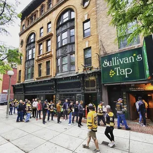 a crowd of people walking down the street