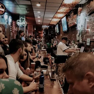 a group of people sitting at a bar