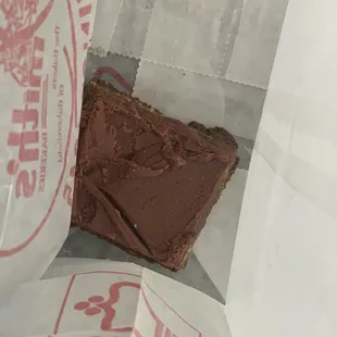 a piece of chocolate cake in a paper bag