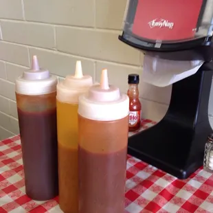 3 proprietary sauces and Frank's Red Hot! Notice the napkin dispenser, yeah, your in the right place! Yes, these table staples, tell it all!