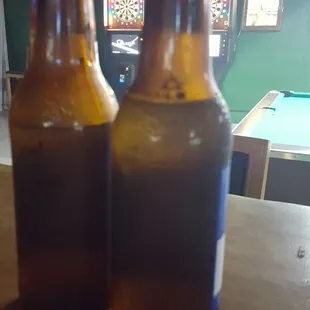 two beer bottles on a table