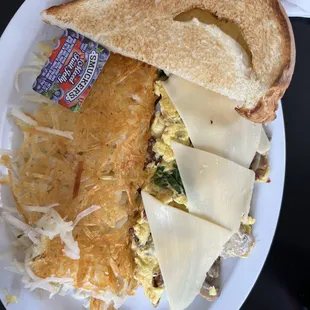 Yummy omelette with homemade bread and perfectly cooked hashbrowns.