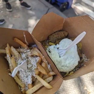 a person holding a box of fries