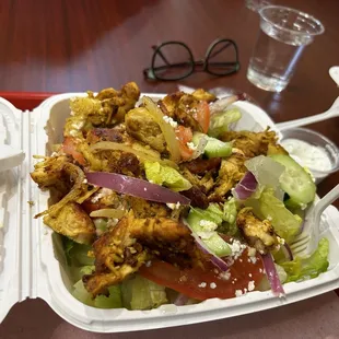 a salad in a styrofoam container