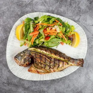 Grilled Mediterranean Dorado
Whole dorado, perfectly grilled to a crispy finish, served with a vibrant seasonal mixed salad.