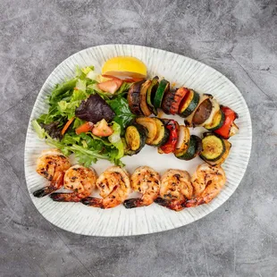 Grilled Shrimp Succulent, marinated shrimp grilled to perfection, served with a fresh mixed salad and a medley of char-grilled vegetables