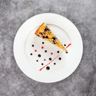 Lemon Blueberry Cheesecake
A velvety cheesecake infused with zesty lemon and swirled with sweet blueberry compote.