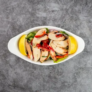 Grilled Mediterranean Octopus, Perfectly charred octopus, marinated with a Turkish herbs and spices, served with refreshing seasonal salad.