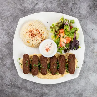 Falafel Entrée
Crispy, golden falafel served on a creamy hummus bed, accompanied by fragrant rice and a fresh, colorful mixed salad.