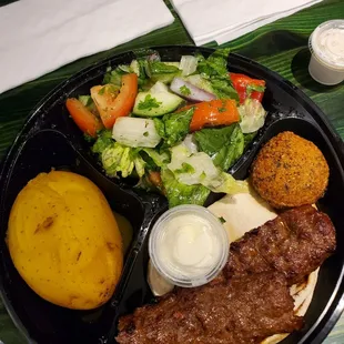 Salad, potato and beef kabob