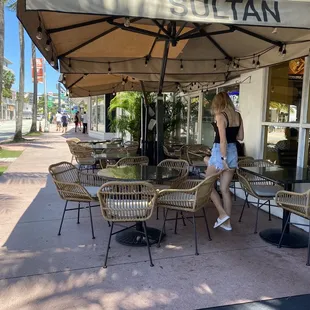 a woman sitting under an umbrella