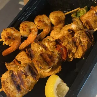 a tray of grilled shrimp and shrimp skewers