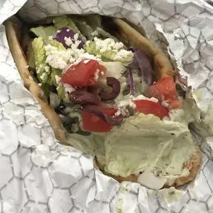 Chicken shawarma with green "Taziki" (spicy) on naan.