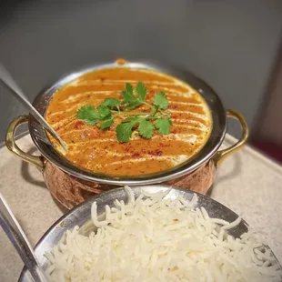 a plate of rice and a bowl of curry