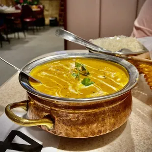 a bowl of soup and a basket of rice