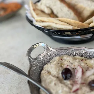 a bowl of hummus and pita chips