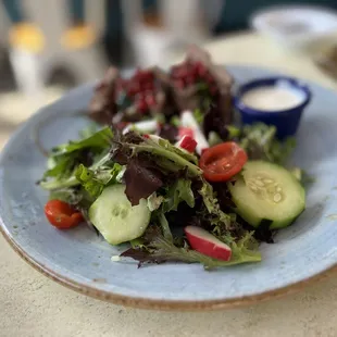 a plate of salad with dressing