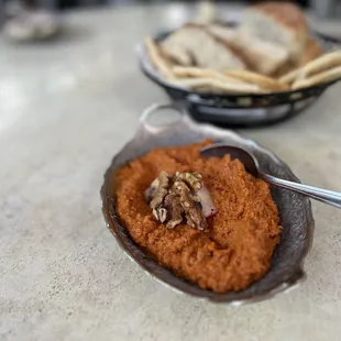 a bowl of hummus and bread