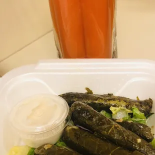 Fresh carrot juice and grape leaves.