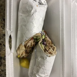 a chicken wrap in a styrofoam container
