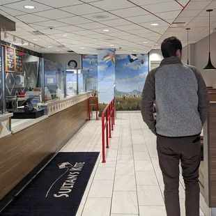 a man standing in a cafeteria