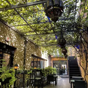 a patio area with tables and chairs