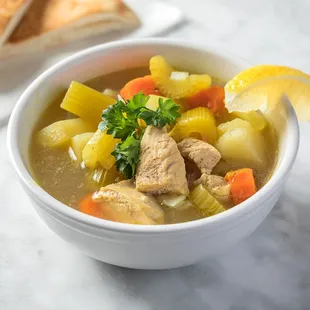 a bowl of soup with meat and vegetables