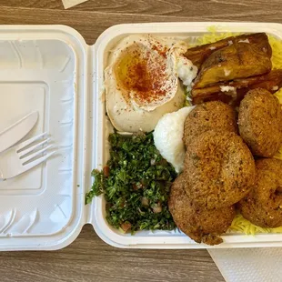 Falafel plate with hummus and tabouleh, rice, and garlic roasted potatoes