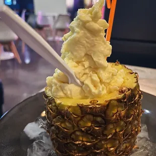 a pineapple topped with ice cream
