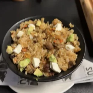  a bowl of fried rice and vegetables